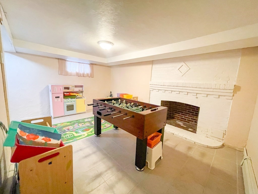 526 Quinobequin Road Newton, MA 02468 - Photo 39 of 42 a living room with a piano table and couch
