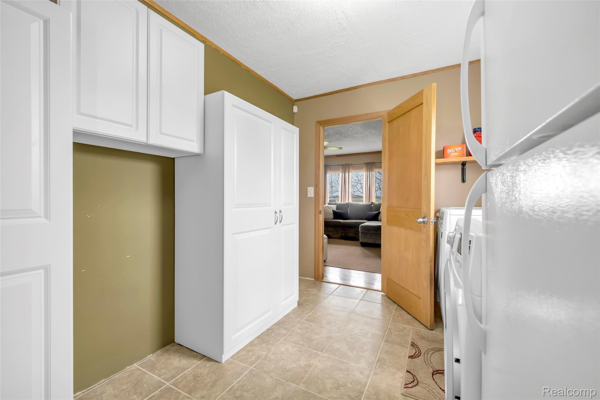 2185 Peet Road New Lothrop, MI 48460 - Photo 18 of 29 Extra Storage in Laundry Room ~ Ceramic Tile Floor
