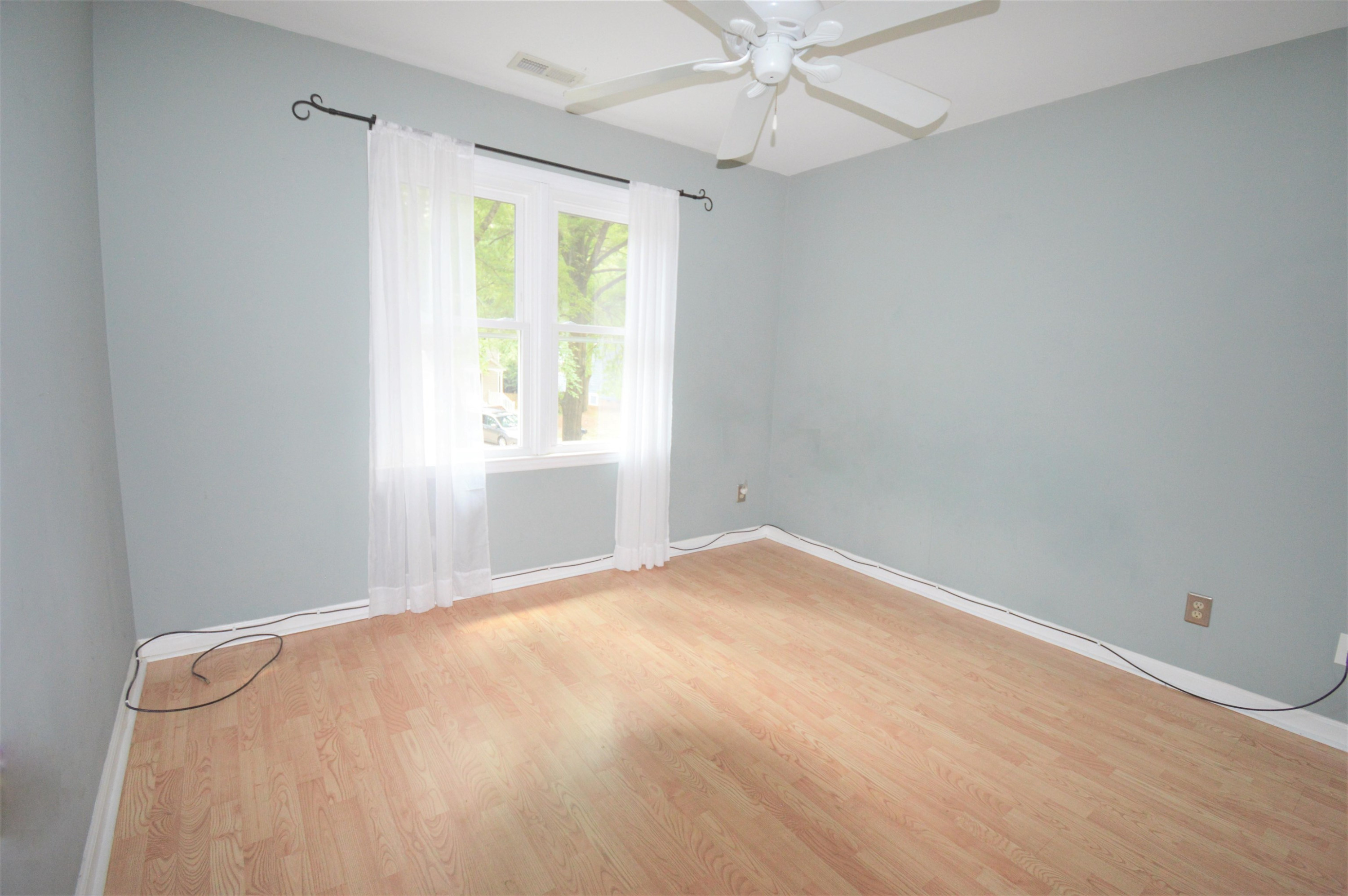 4965 Royal Adelaide Way Raleigh, NC 27604 - Photo 20 of 41 This bedroom has a laminate floor and an extra long cable that could be shortened or rolled up. The windows look out onto the front cul-de-sac. Front Secondary Bedroom