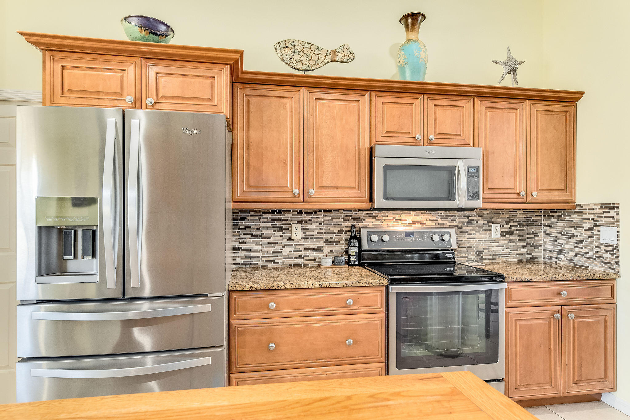 1566 Eagles Circle Sebastian, FL 32958 - Photo 18 of 74 a kitchen with stainless steel appliances granite countertop a refrigerator stove and sink with granite countertops