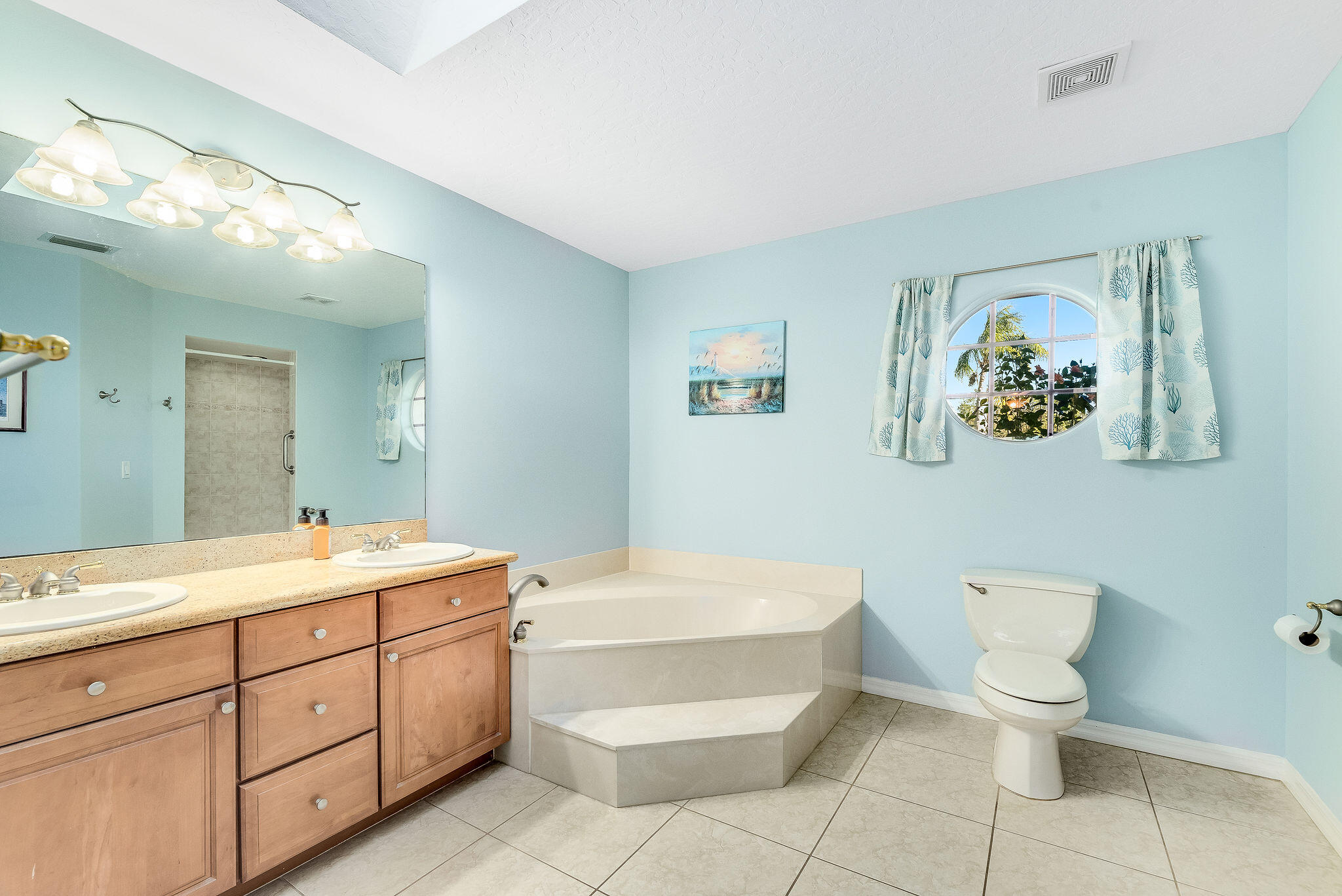 1566 Eagles Circle Sebastian, FL 32958 - Photo 27 of 74 a spacious bathroom with a toilet sink and mirror