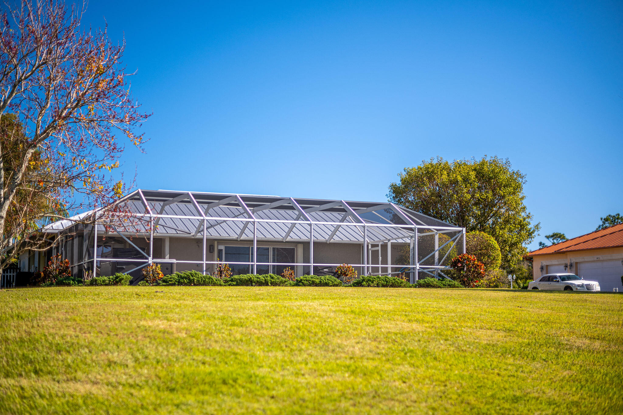 1566 Eagles Circle Sebastian, FL 32958 - Photo 45 of 74 a view of a swimming pool with a lawn chairs under an umbrella