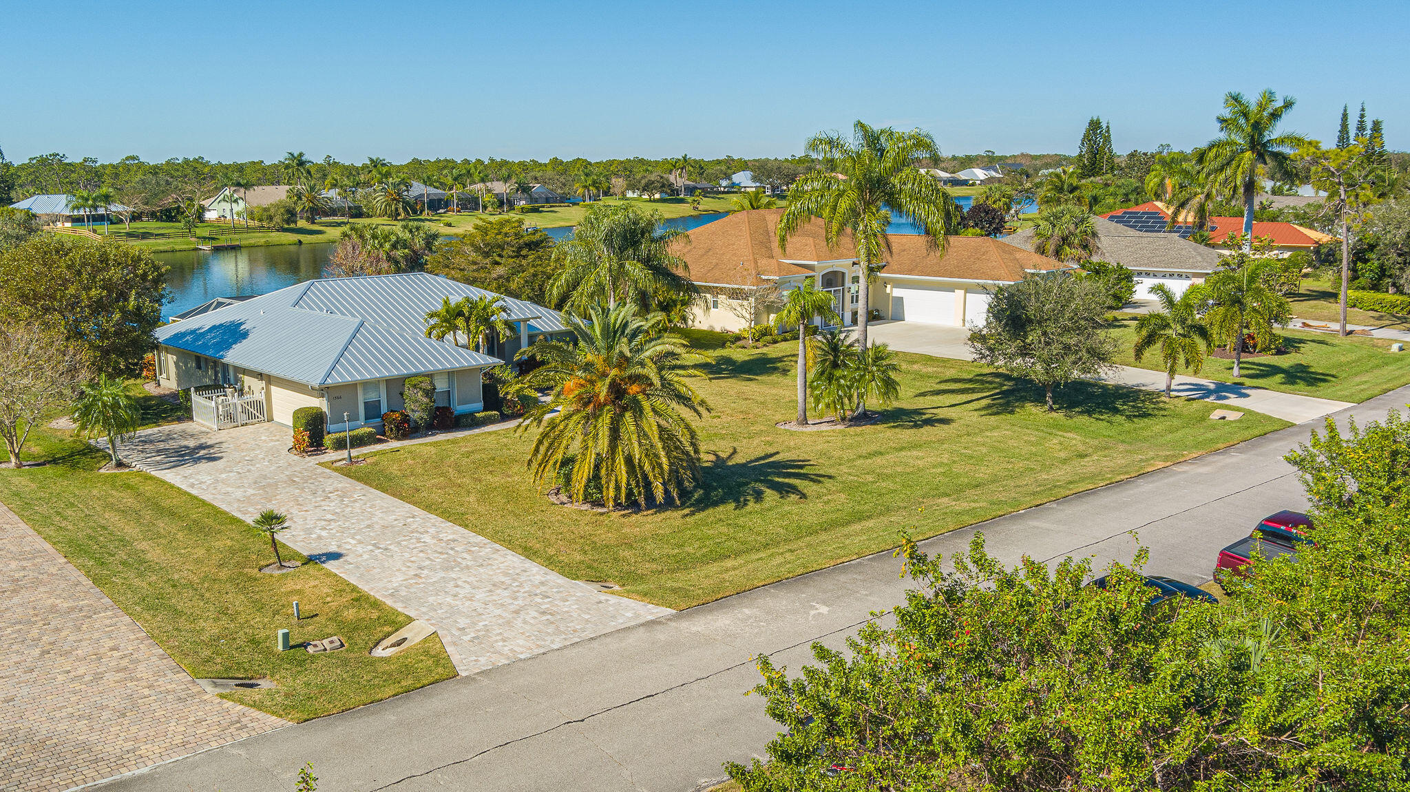 1566 Eagles Circle Sebastian, FL 32958 - Photo 5 of 74 a view of a swimming pool with a lawn chairs under an umbrella