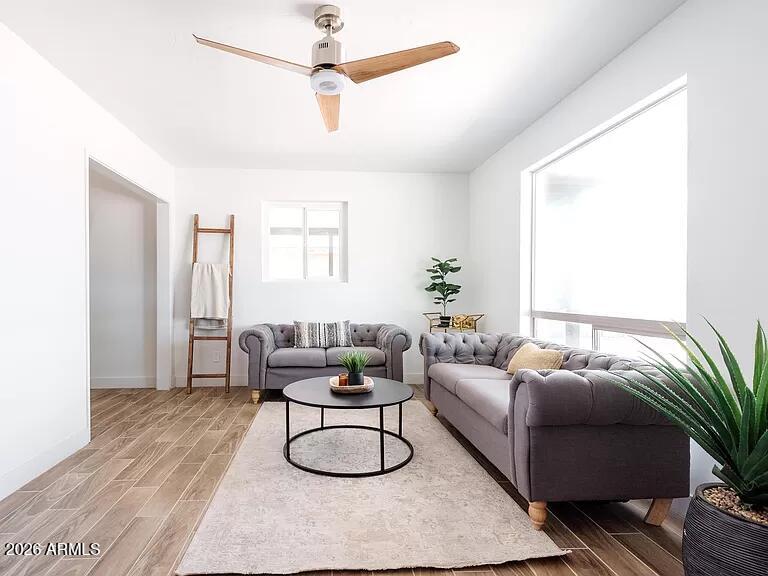 2915 West Griswold Road Phoenix, AZ 85051 - Photo 4 of 17 a living room with furniture a ceiling fan and a potted plant