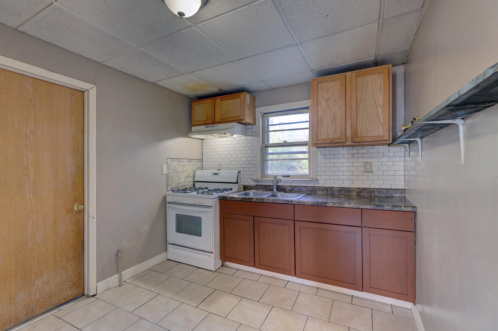 1025 North Rand Road Prospect Heights, IL 60070 - Photo 4 of 16 a kitchen with a sink stove and cabinets