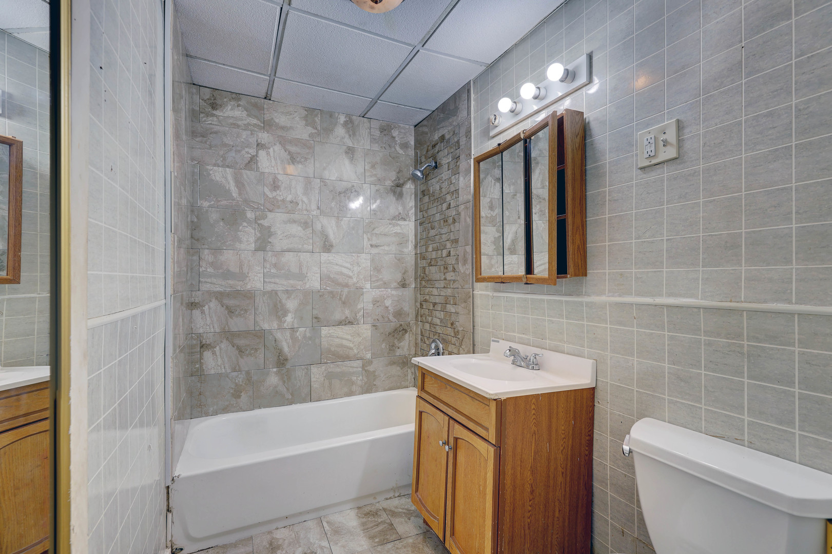 1025 North Rand Road Prospect Heights, IL 60070 - Photo 9 of 16 a bathroom with a sink a toilet and shower
