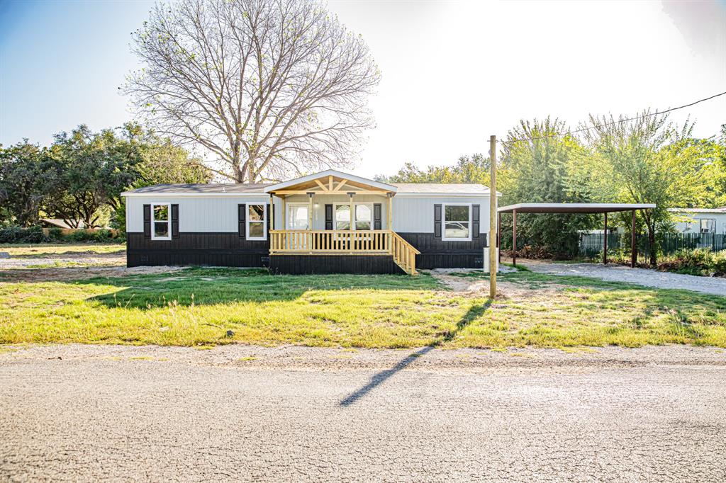 123 Kelly Azle, TX 76020 - Photo 1 of 28 a front view of a house with a yard