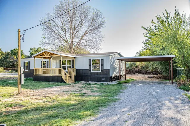 a front view of a house with a yard and pathway