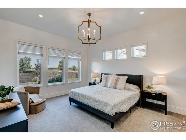 a living room with a bed furniture and a large window