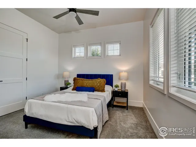 a bedroom with a bed and a night stand