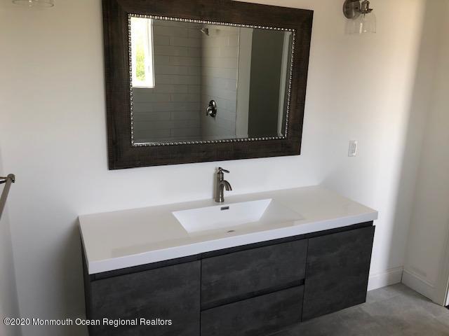 125 Shore Drive Brick, NJ 08723 - Photo 27 of 83 a bathroom with a sink and a mirror