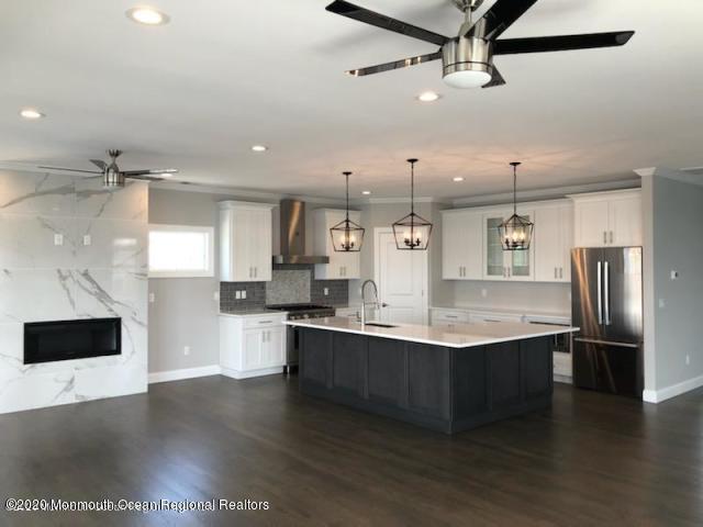 125 Shore Drive Brick, NJ 08723 - Photo 35 of 83 a kitchen with stainless steel appliances granite countertop a sink a stove and a refrigerator