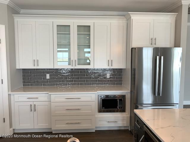 125 Shore Drive Brick, NJ 08723 - Photo 37 of 83 a kitchen with granite countertop a refrigerator and a stove