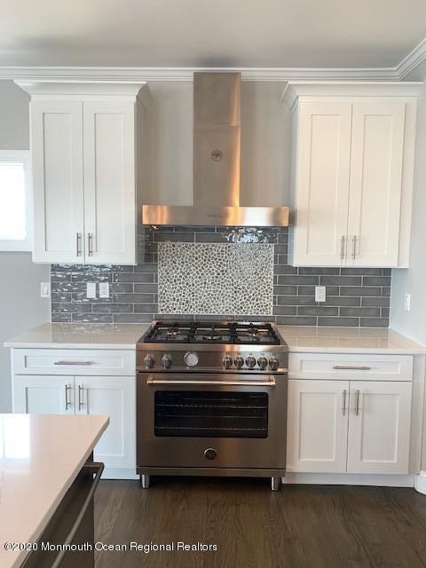 125 Shore Drive Brick, NJ 08723 - Photo 38 of 83 a kitchen with a stove and white cabinets