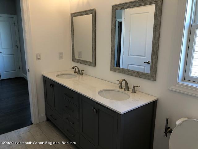 125 Shore Drive Brick, NJ 08723 - Photo 47 of 83 a bathroom with a sink and a mirror