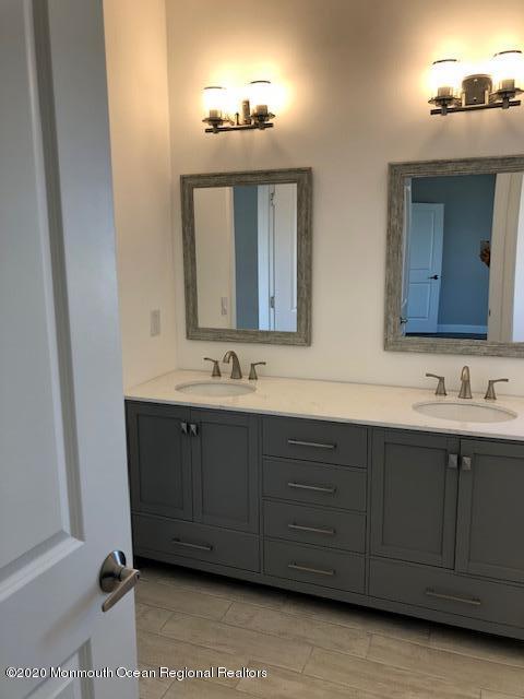 125 Shore Drive Brick, NJ 08723 - Photo 48 of 83 a bathroom with a double vanity sink and a mirror