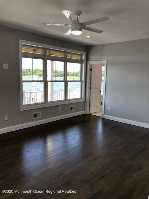 125 Shore Drive Brick, NJ 08723 - Photo 52 of 83 a view of empty room with wooden floor and fan