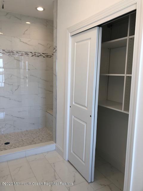 125 Shore Drive Brick, NJ 08723 - Photo 56 of 83 a bathroom with a glass shower door