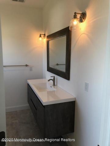 125 Shore Drive Brick, NJ 08723 - Photo 58 of 83 a bathroom with a sink and a mirror