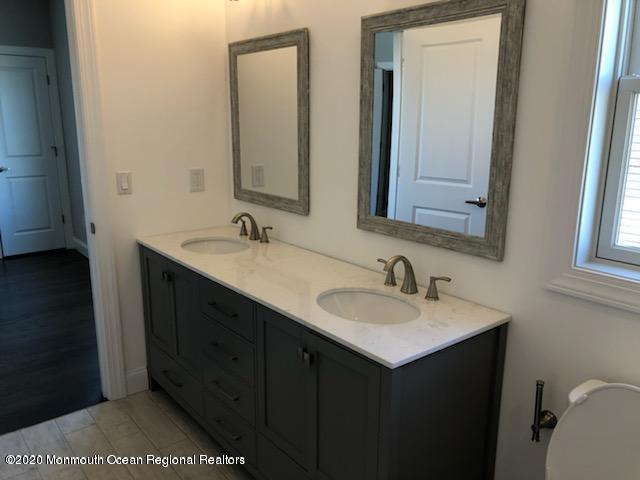 125 Shore Drive Brick, NJ 08723 - Photo 59 of 83 a bathroom with a sink and a mirror