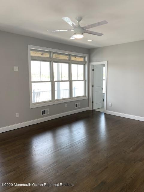 125 Shore Drive Brick, NJ 08723 - Photo 63 of 83 an empty room with wooden floor and windows