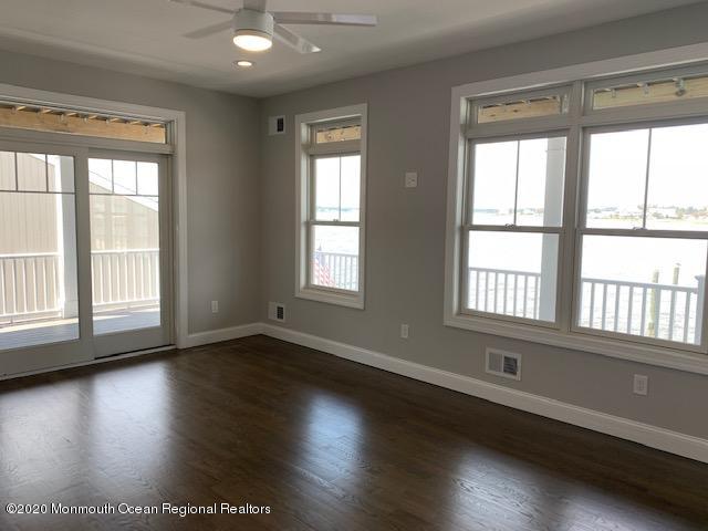 125 Shore Drive Brick, NJ 08723 - Photo 64 of 83 a view of an empty room with wooden floor and a window