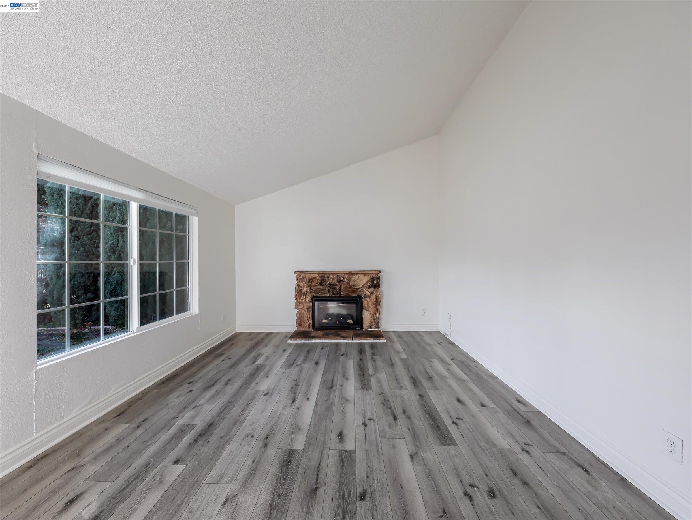 3432 Danielle Place Bay Point, CA 94565 - Photo 4 of 36 a view of an empty room with wooden floor and a window