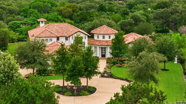 a view of a garden with a table and chairs under an umbrella