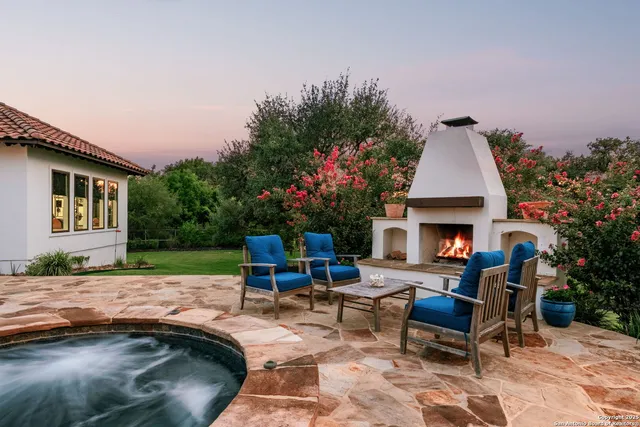 a backyard of a house with table and chairs