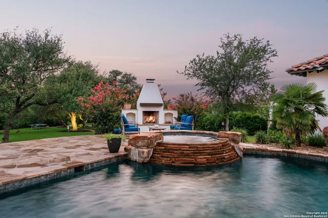 a view of a house with pool and sitting area