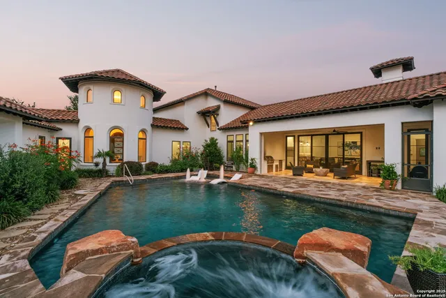 a swimming pool with outdoor seating and yard