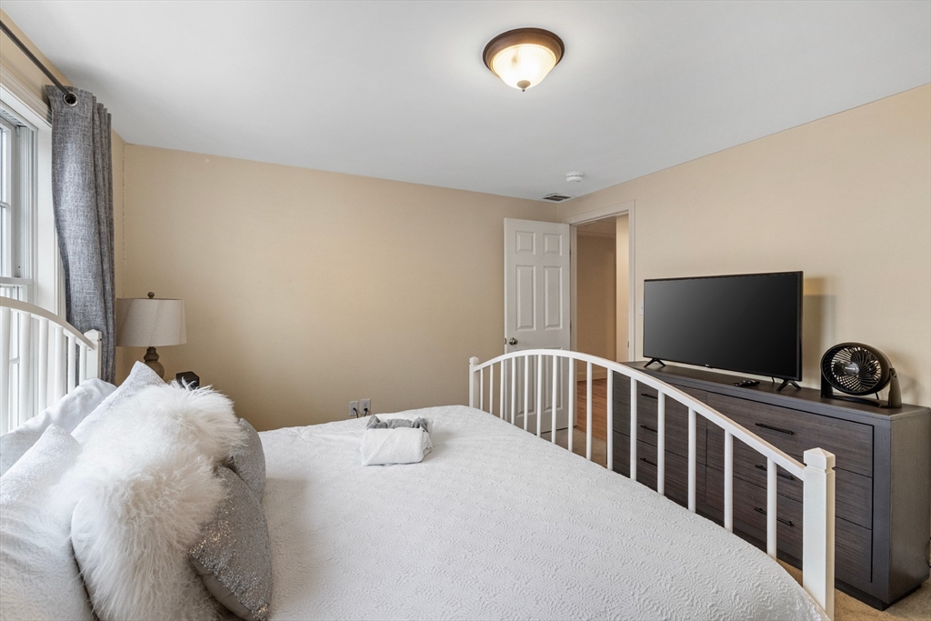 26 Central Street Manchester, MA 01944 - Photo 13 of 15 a bedroom with a bed and a flat screen tv