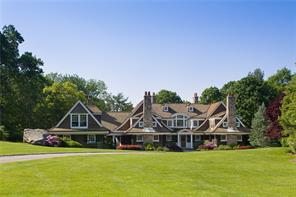 212-214 Trinity Pass Road Pound Ridge, NY 10576 - Photo 1 of 1 a front view of a house with a big yard and potted plants