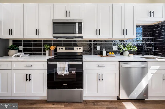 a kitchen with cabinets and stainless steel appliances