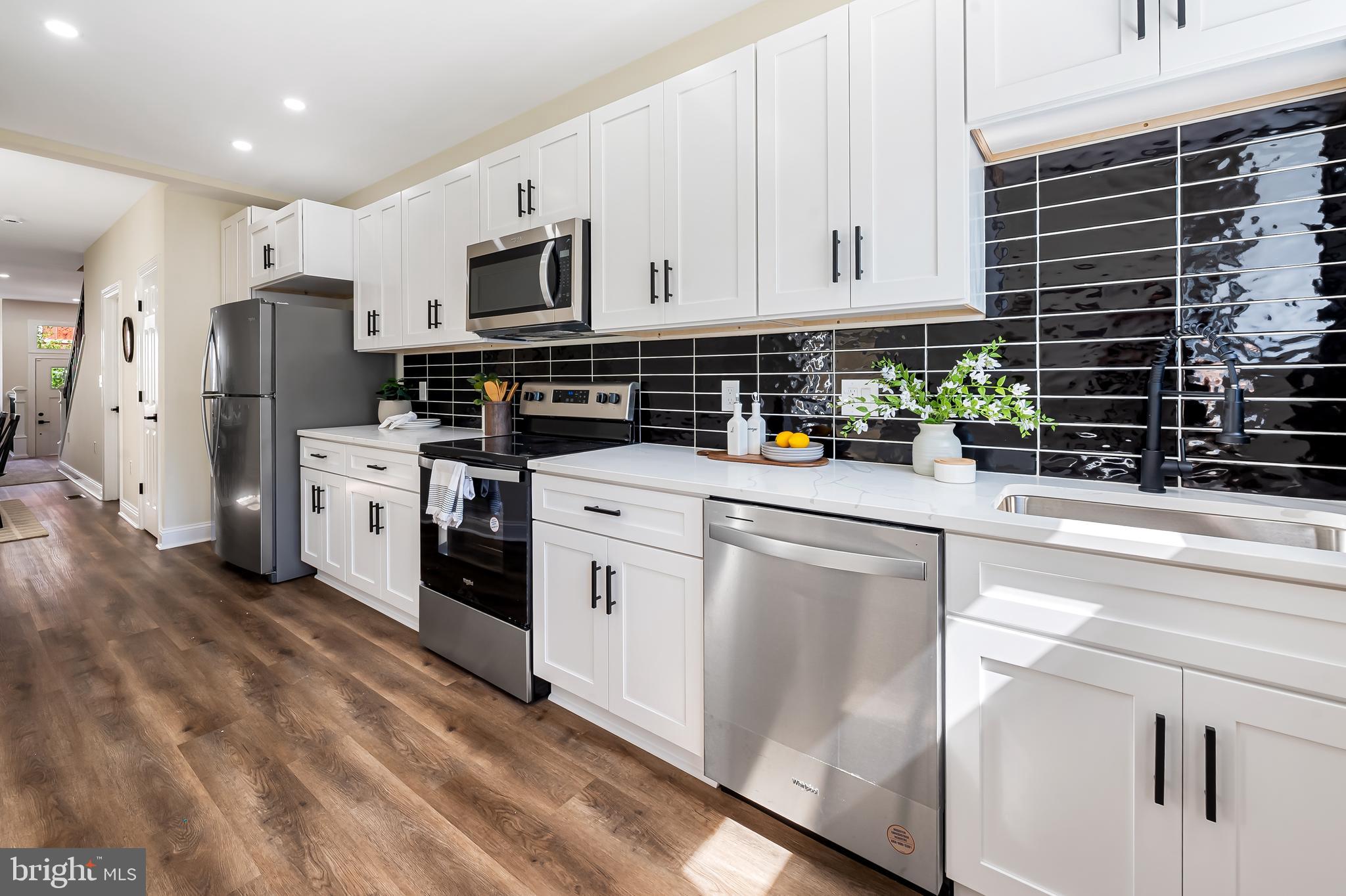 1722 McCulloh Street Baltimore, MD 21217 - Photo 12 of 36 a kitchen with stainless steel appliances a refrigerator sink and cabinets