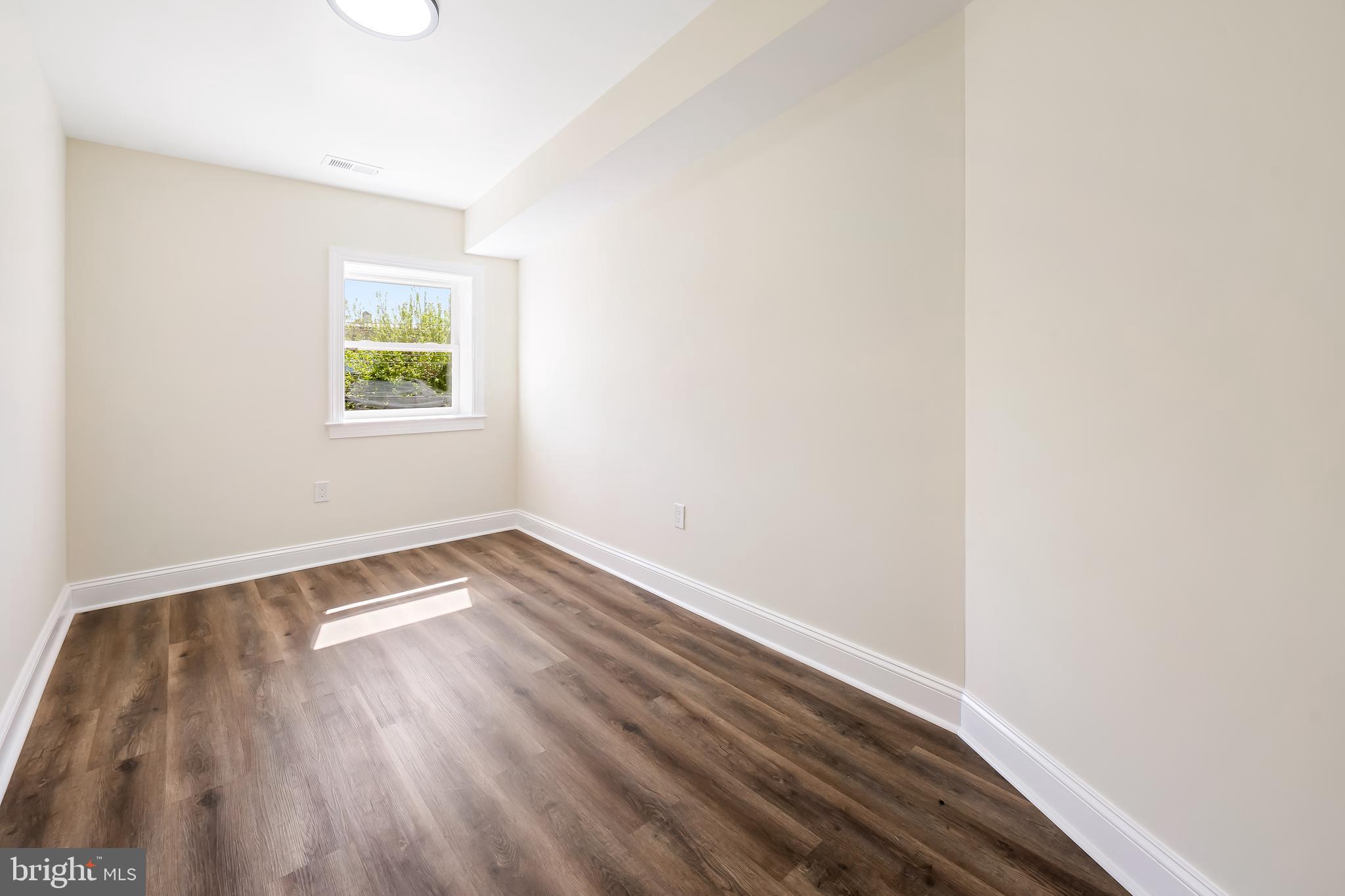 1722 McCulloh Street Baltimore, MD 21217 - Photo 18 of 36 a view of an empty room with wooden floor and a window