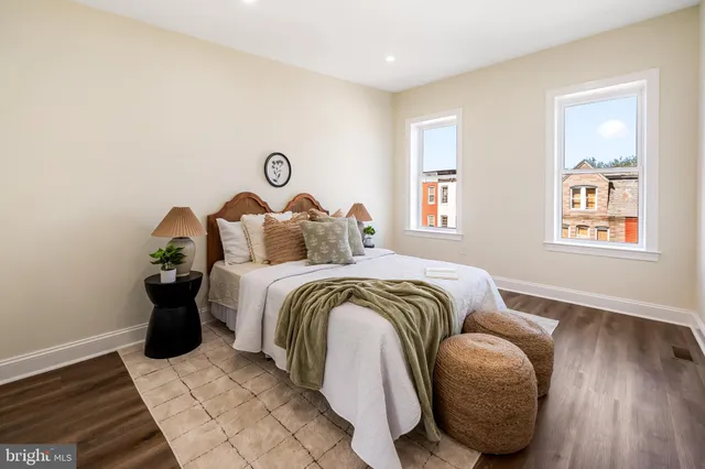 a bedroom with a bed and wooden floor