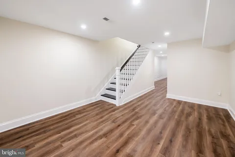 a view of an empty room with stairs and ventilation