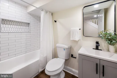 a white toilet sitting next to a bathroom sink
