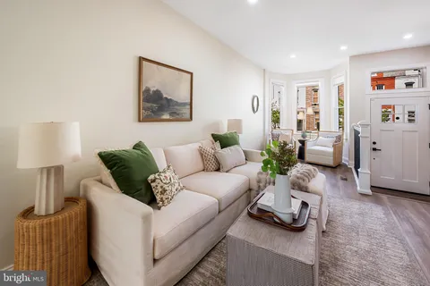 a living room with furniture and a lamp