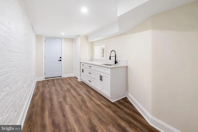 a view of a hallway with wooden floor