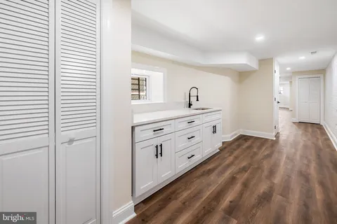 a room with a bed and a dresser