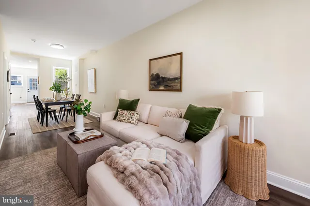 a living room with a couch and a potted plant