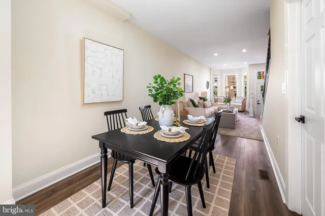 a dining room with furniture and wooden floor