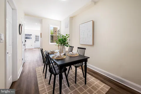 a view of a room with a table and chairs