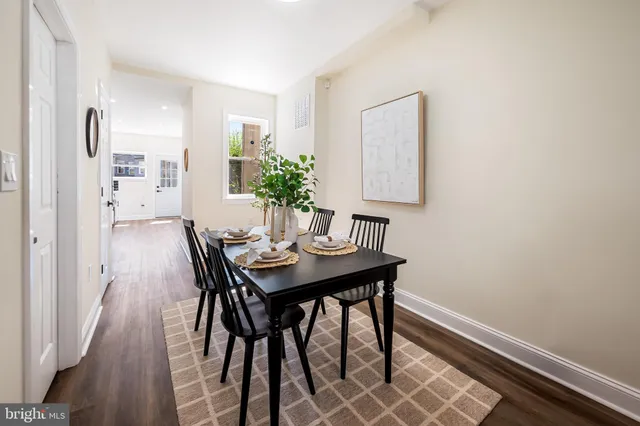 a view of a room with a table and chairs