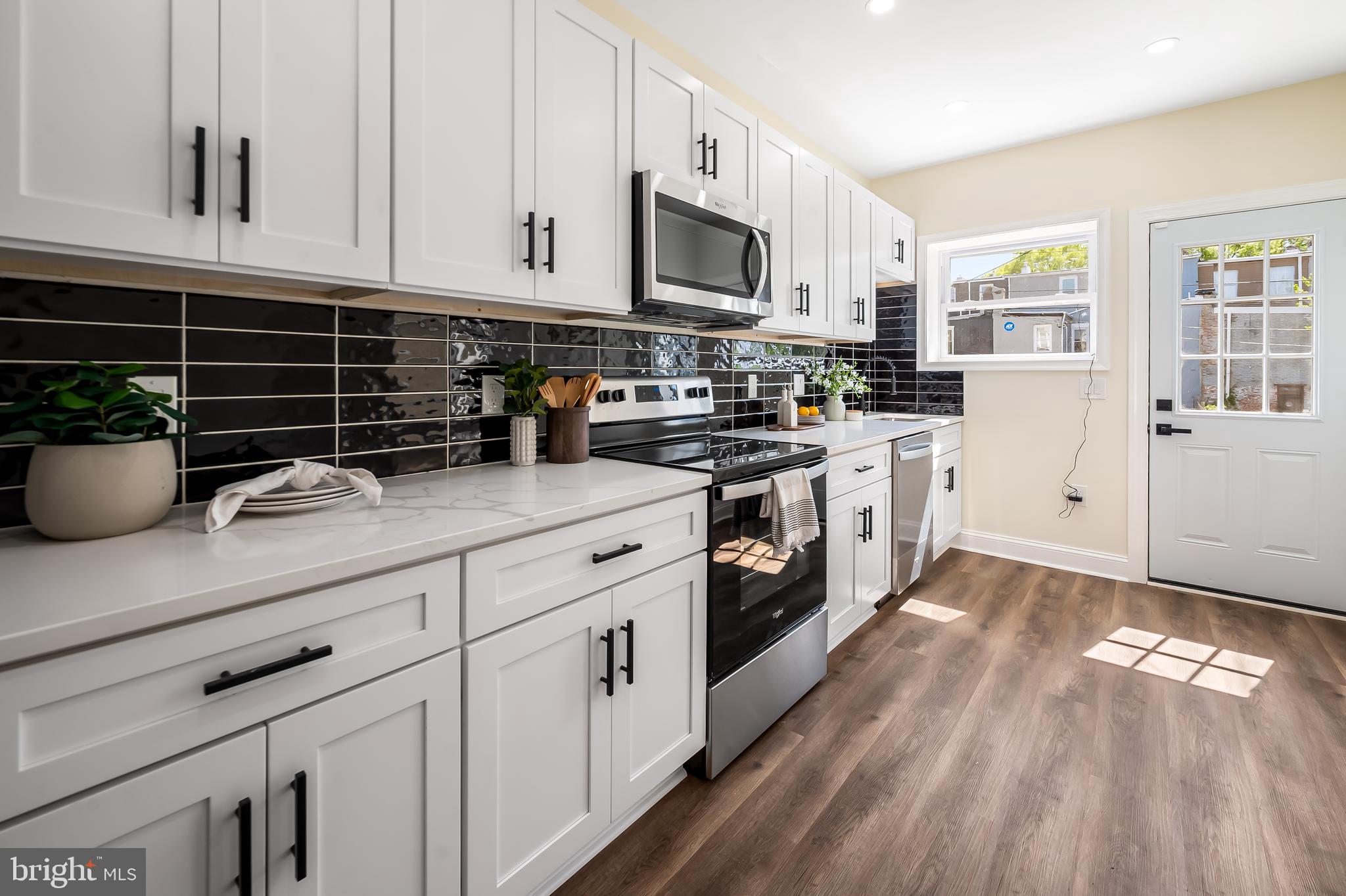 1722 McCulloh Street Baltimore, MD 21217 - Photo 9 of 36 a kitchen with appliances a sink and cabinets