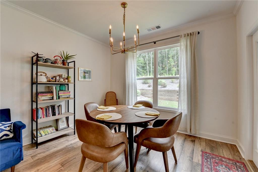 2129 Charmond Drive Monroe, GA 30656 - Photo 13 of 37 a dining room with furniture window and wooden floor