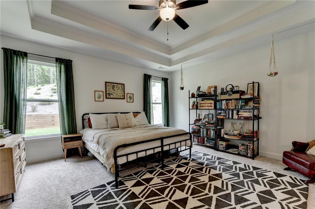 2129 Charmond Drive Monroe, GA 30656 - Photo 14 of 37 a bedroom with a bed and a chandelier