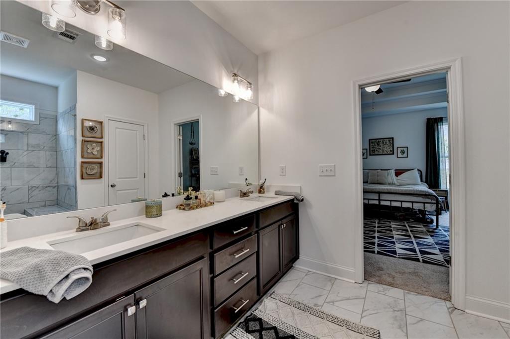2129 Charmond Drive Monroe, GA 30656 - Photo 17 of 37 a bathroom with a sink double vanity and a mirror